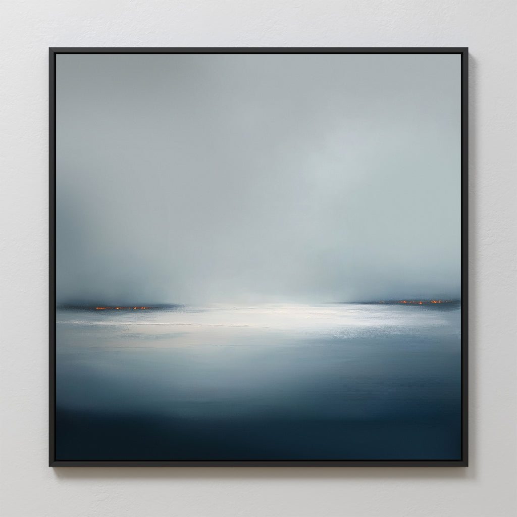 Emberline Stillness Canvas Art features a serene, misty landscape with calm water and soft orange shoreline lights. Its cool blue and gray tones bring minimalist, tranquil style to any modern interior.