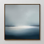 The Emberline Stillness Canvas Art is a framed abstract painting for bedroom decor, showcasing a misty blue-gray landscape with a bright white center and orange accents, creating intriguing minimalist wall art for modern interiors.