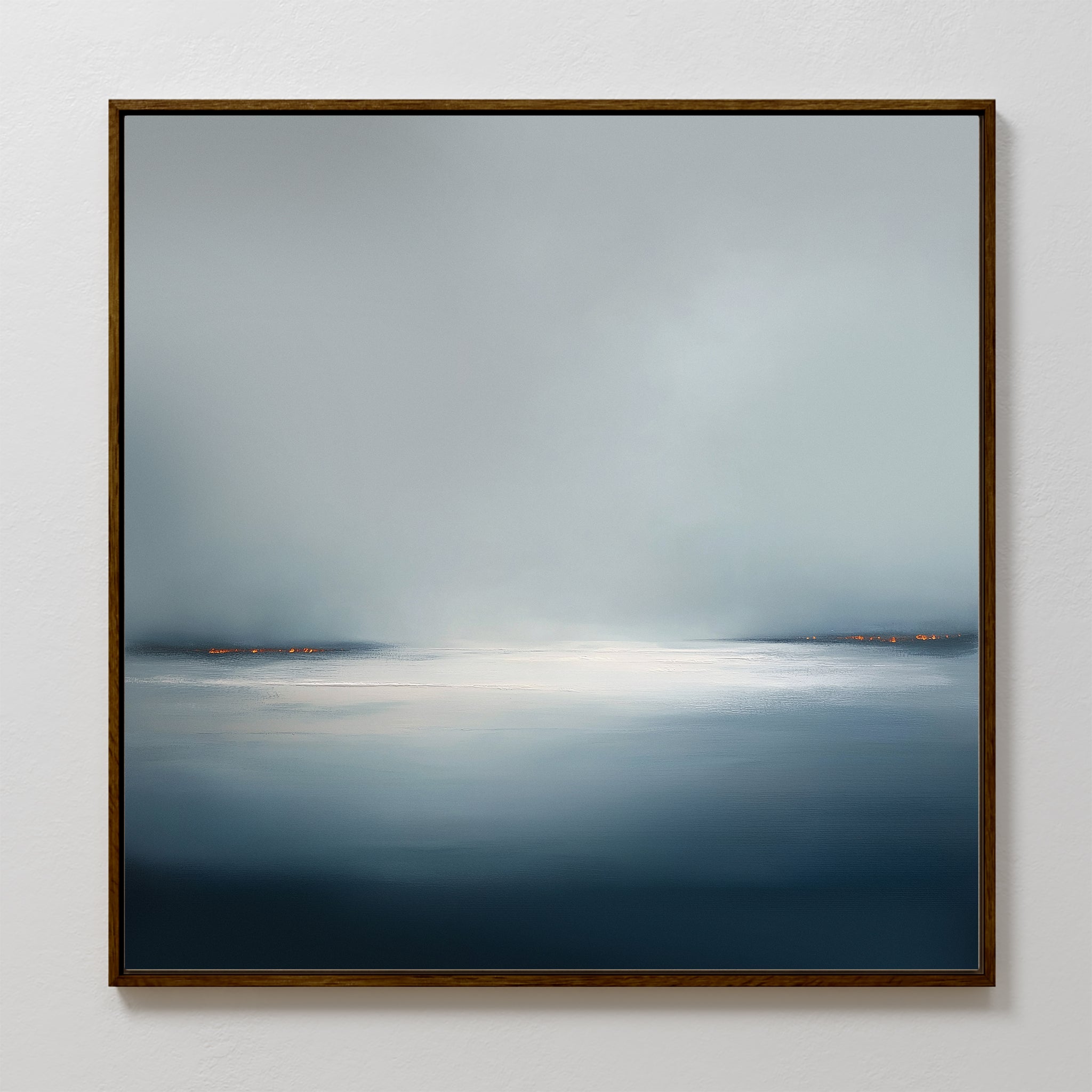 The Emberline Stillness Canvas Art is a framed abstract painting for bedroom decor, showcasing a misty blue-gray landscape with a bright white center and orange accents, creating intriguing minimalist wall art for modern interiors.