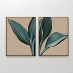 The Emerald Poise Set of 2 features minimalist wall art prints with bold green leaves on a beige backdrop. Displayed together, they create a cohesive botanical look—ideal for adding stylish flair to any living room wall.