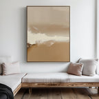 A minimalist living room with light wood sofas, cream and beige cushions, and the Ethereal Plains Abstract Canvas Art in beige and white hanging on a white wall. Natural light streams in from the right.