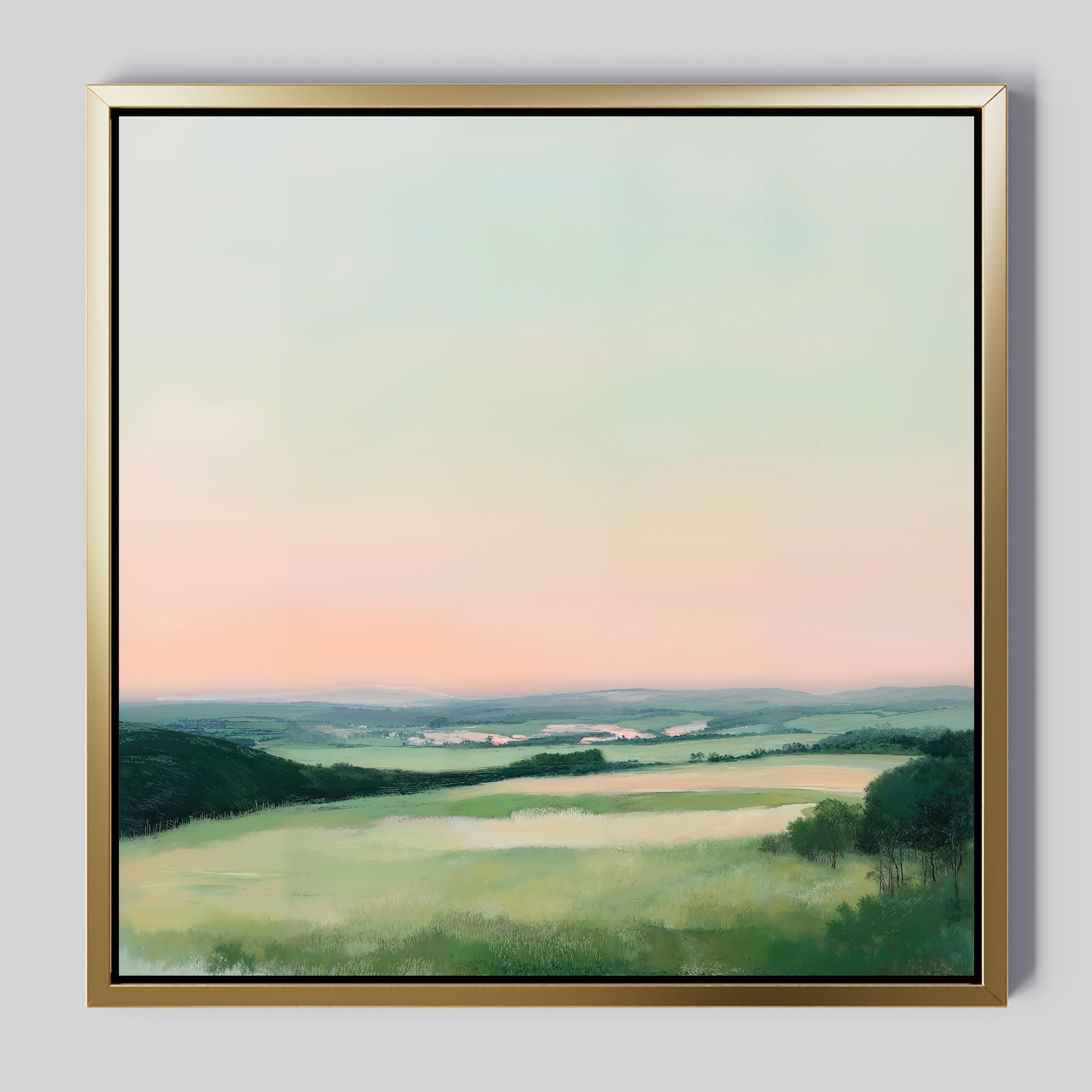 Evening Hues Abstract Canvas Art features a tranquil landscape with green fields, hills, a winding river, and a blue-peach pastel sky. The elegant gold frame makes it perfect for adding style to your living room against a light gray wall.