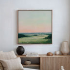 The Evening Hues Abstract Canvas Art hangs above a wooden sideboard adorned with vases, a candle, and stacked books, creating a serene setting with neutral tones and minimalist living room decor.