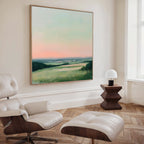 A modern living room with a white leather lounge chair and ottoman, a wooden side table with a white lamp, and the Evening Hues Abstract Canvas Art—an ideal centerpiece for stylish living room decor.
