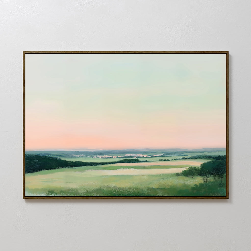 Evening Hues Canvas Art – Horizontal: Framed wall art showcasing rolling green fields, tree clusters, and a pastel pink and blue sky—ideal large decor for your living room.