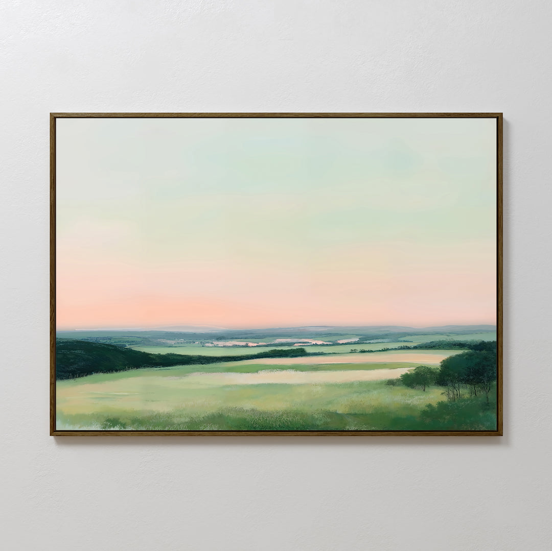 Evening Hues Canvas Art – Horizontal: Framed wall art showcasing rolling green fields, tree clusters, and a pastel pink and blue sky—ideal large decor for your living room.