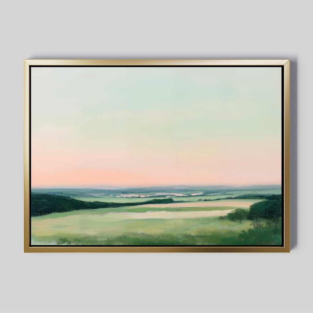 The "Evening Hues Canvas Art – Horizontal" showcases green fields, distant hills, and a pastel sky at dusk—ideal framed wall decor for living rooms with light gray walls.