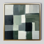 Evergreen Abstract Canvas Art showcases overlapping green, black, gray, and white rectangles in a grid pattern. This modern wall art features a thin gold frame and a light background for a sleek look.
