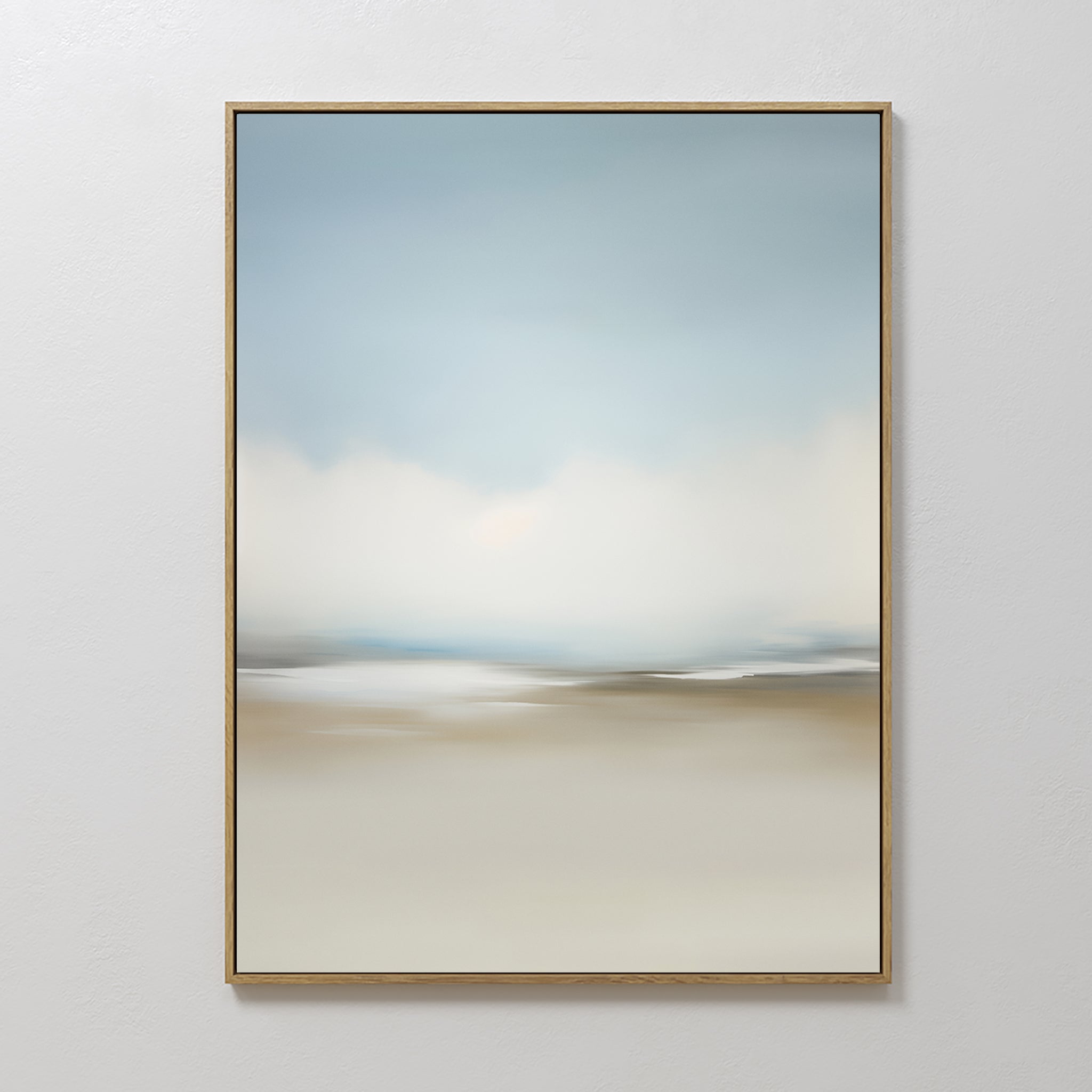 Faded Silence Canvas Art features soft, blurred blue, white, and beige tones suggesting a serene minimalist landscape. This framed abstract piece adds calm elegance to any plain white wall.