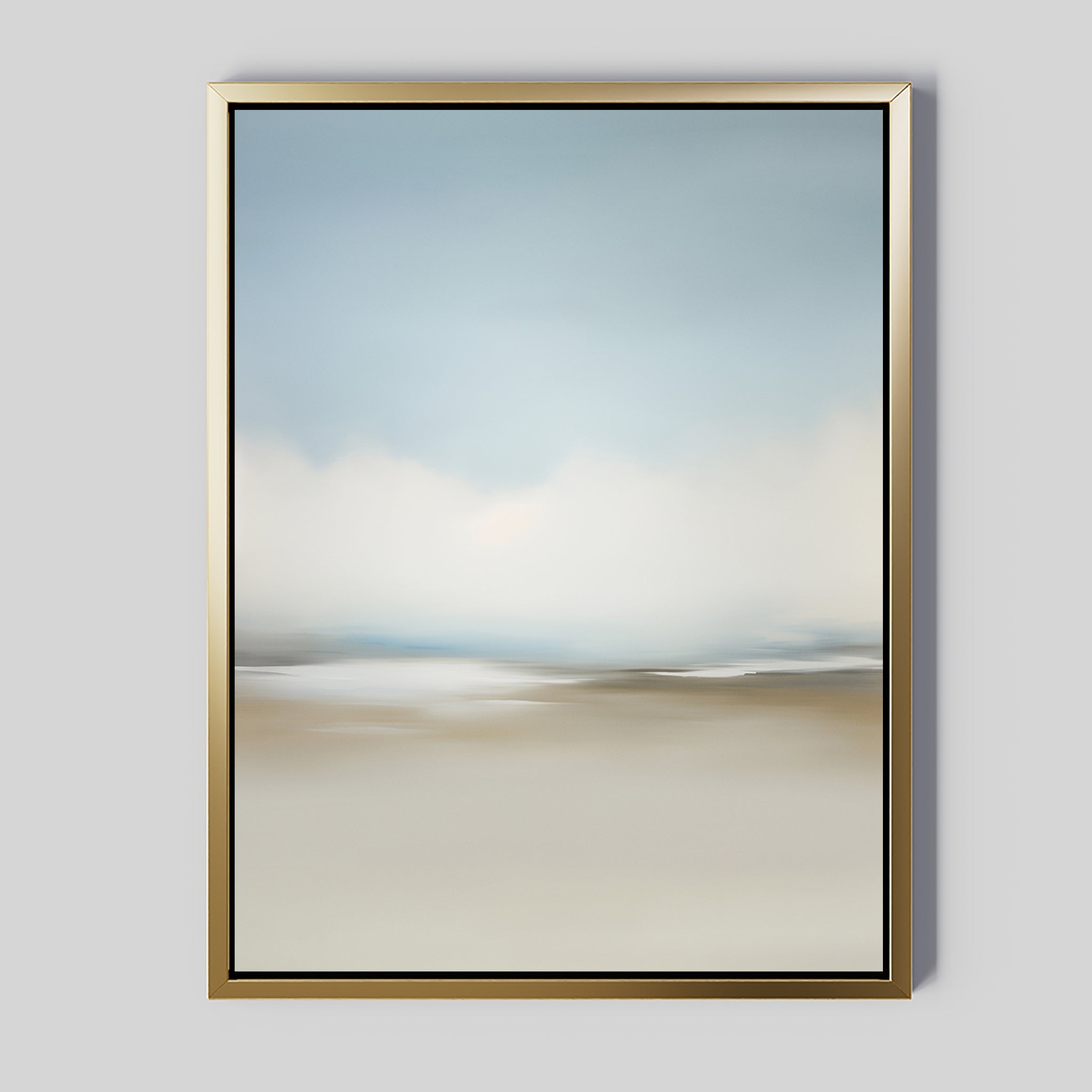The Faded Silence Canvas Art is a framed abstract piece with soft, blurred blue, white, and beige tones in a minimalist design. This wall art features a gold frame and is displayed against a light gray wall.