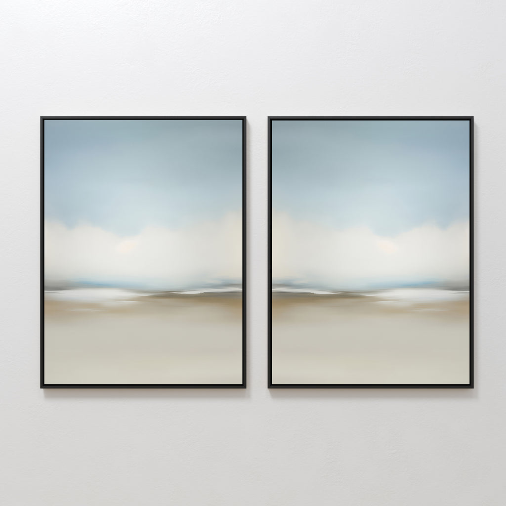 The Faded Silence Set of 2 features abstract wall art with soft, blurred beige, blue, and white tones. These framed pieces create a serene landscape look—ideal minimalist decor for modern spaces when hung side by side on a white wall.