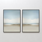 The Faded Silence Set of 2 features abstract wall art with soft, blurred beige, blue, and white tones. These framed pieces create a serene landscape look—ideal minimalist decor for modern spaces when hung side by side on a white wall.
