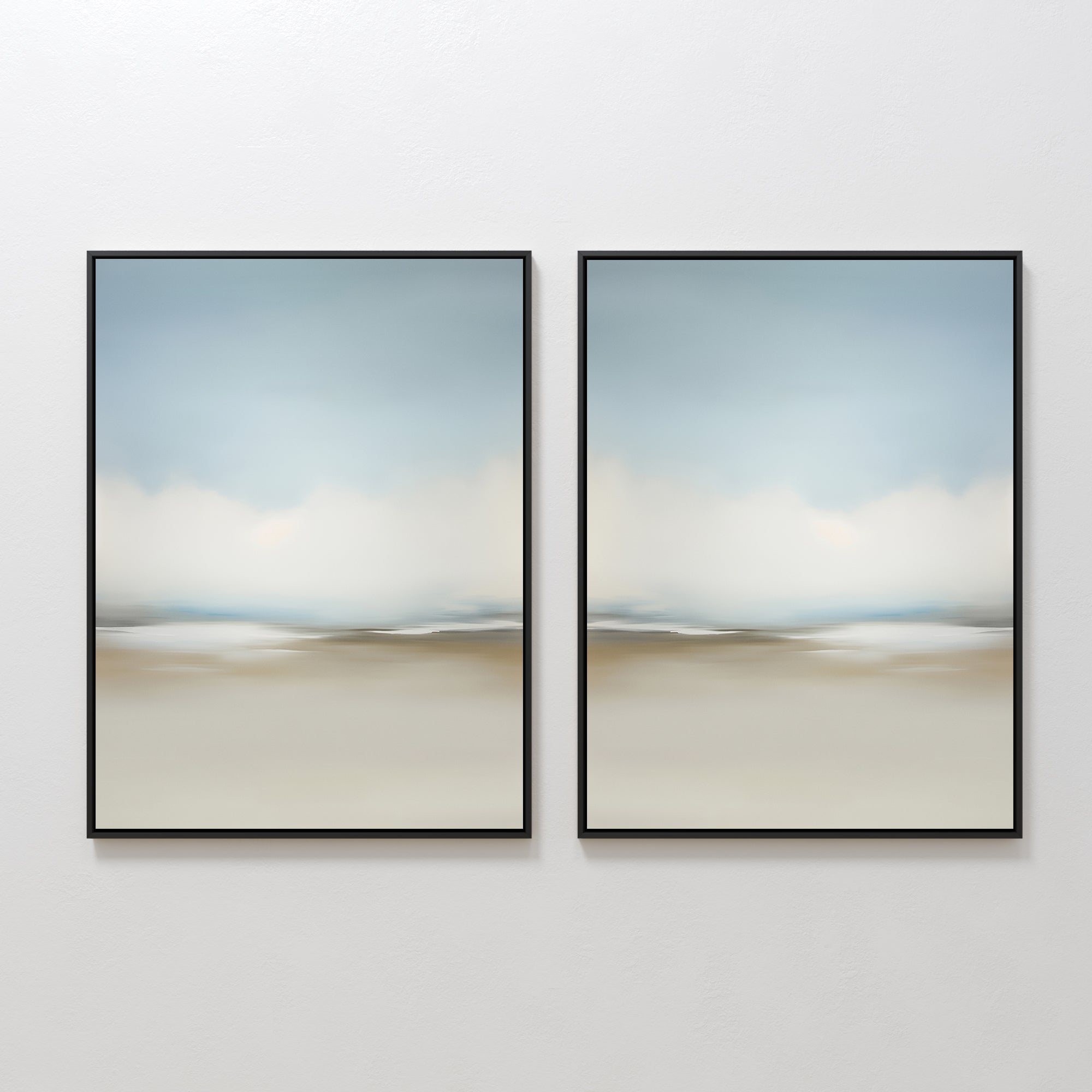 The Faded Silence Set of 2 features abstract wall art with soft, blurred beige, blue, and white tones. These framed pieces create a serene landscape look—ideal minimalist decor for modern spaces when hung side by side on a white wall.