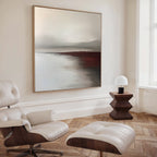 A modern living room with a white leather lounge chair and ottoman, a wooden side table with a white lamp, and the Fading Light Canvas Art as striking landscape wall art in muted tones.