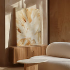 A minimalist room with elegant decor features a wooden console displaying the Feathered Touch Abstract Canvas Art, beside a curved white textured sofa and round white coffee table, all bathed in natural sunlight.