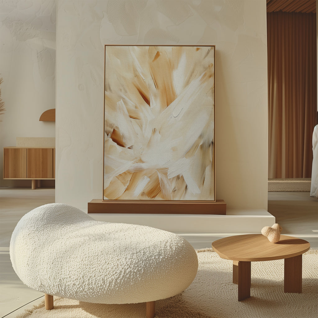 A modern living space features a textured white lounge chair, a small wooden table with two hearts, and the Feathered Touch Abstract Canvas Art leaning against a cream wall, while warm natural light highlights the elegant decor.