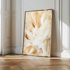 The Feathered Touch Abstract Canvas Art, featuring beige, cream, and white brushstrokes, leans against the wall in a bright room with white paneling and herringbone floors—an elegant statement piece for stylish home decor.
