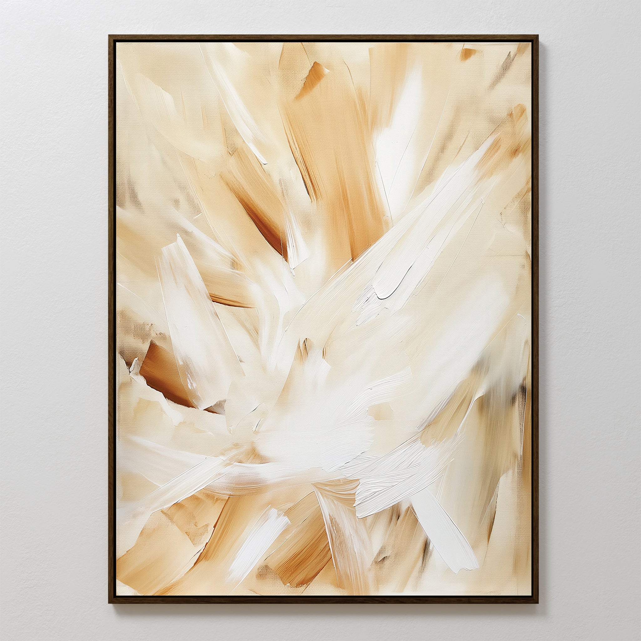 Feathered Touch Abstract Canvas Art features sweeping brushstrokes in beige, tan, and white. This framed wall art print creates a dynamic look against a white wall—perfect for adding elegant style to your home decor.