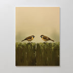 The Fence Companions Canvas Art features two small brown and yellow birds facing each other on a weathered wooden fence, set against a soft beige background—an ideal accent for adding charm to rustic bedroom decor.