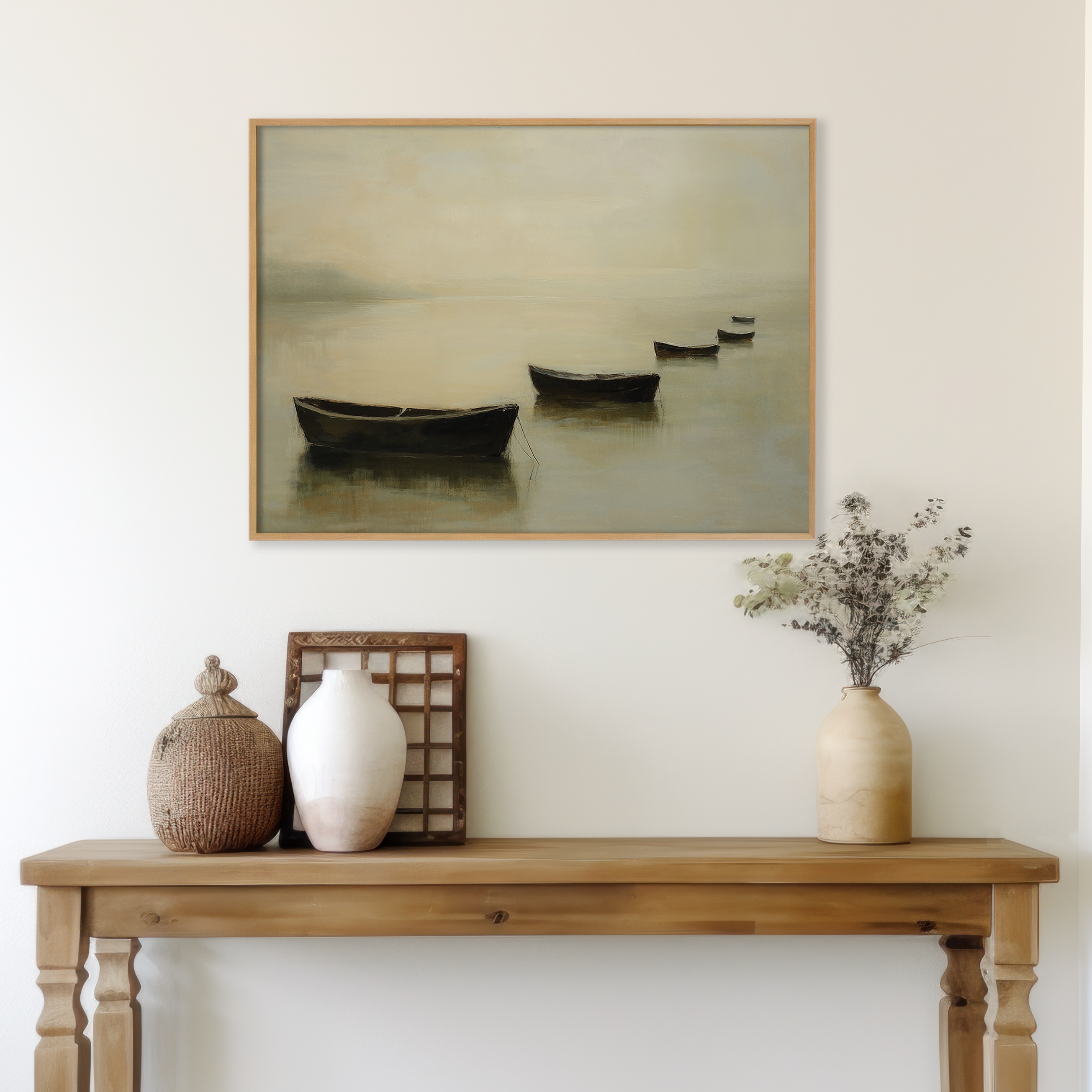 A wooden console table displays ceramic vases, a woven container, and dried flowers. Above, the Floating Dreams Canvas Art depicts boats on calm water, hanging on a light wall for a tranquil, minimalist look.