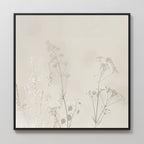 Floral Symphony Abstract Canvas Art showcases delicate, neutral wildflower silhouettes on a light beige background in a sleek black frame—an elegant, minimalist addition to your living room decor.