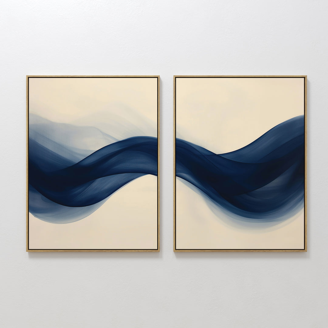 The Flowing Indigo Set of 2 showcases side-by-side abstract wall art with overlapping navy blue waves on a beige background, ideal for adding modern harmony and style to minimalist interiors or enhancing your living room decor.