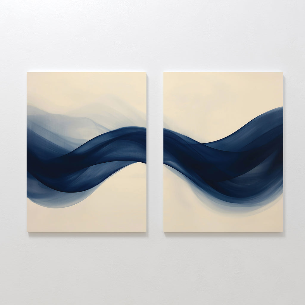 The Flowing Indigo Set of 2 features square canvases with abstract navy blue waves on a light beige background, creating striking modern wall art that enhances minimalist interiors and living room decor.