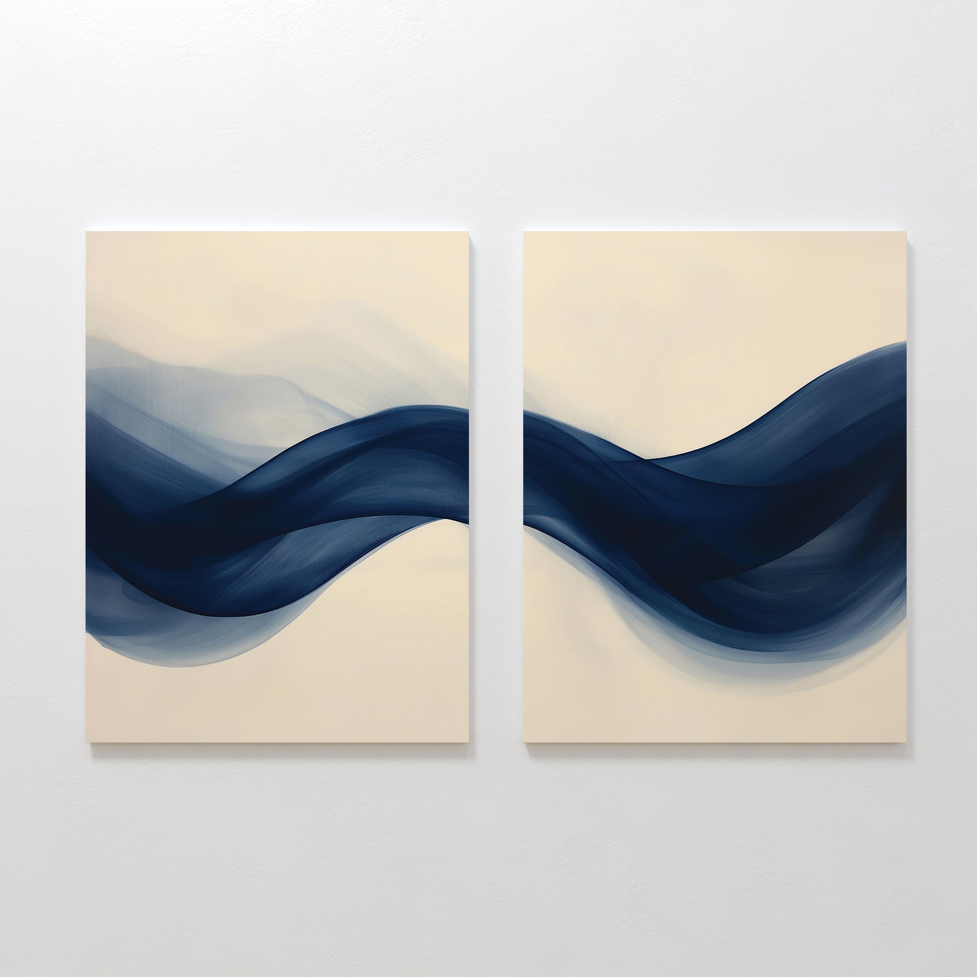 The Flowing Indigo Set of 2 features square canvases with abstract navy blue waves on a light beige background, creating striking modern wall art that enhances minimalist interiors and living room decor.