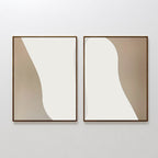 Flowing Silhouettes Set of 2 features abstract art prints in brown frames with curved beige and white shapes, bringing a modern, minimalistic touch to your living room wall decor.