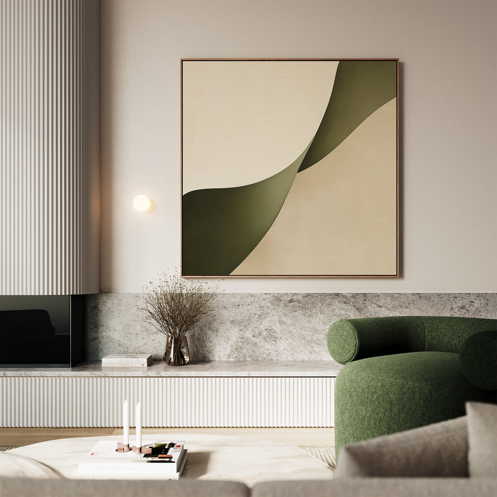 A modern living room with minimalist decor, soft neutral walls, a round green sofa, a marble shelf with dried florals, and the Forest Flow Canvas Art—a large abstract painting in beige and green tones.