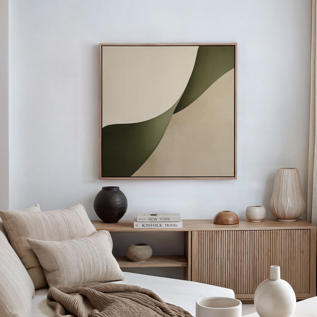 A modern living room features a beige sofa, neutral cushions, minimalist decor, a wooden sideboard with accents, and the Forest Flow Canvas Art in green and beige. Natural light streams through windows with light curtains.