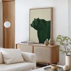 A modern living room with a light sofa, round coffee table, and sideboard topped with books and vases. Above the sideboard hangs the striking Forest Guardian Canvas Art. A potted plant brings a fresh touch to the stylish modern rustic decor.