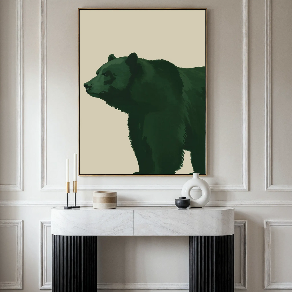 The Forest Guardian Canvas Art, featuring a green bear in a frame, hangs above a white marble console table with candles, a bowl, and a white vase—an ideal modern rustic decor accent for your space.