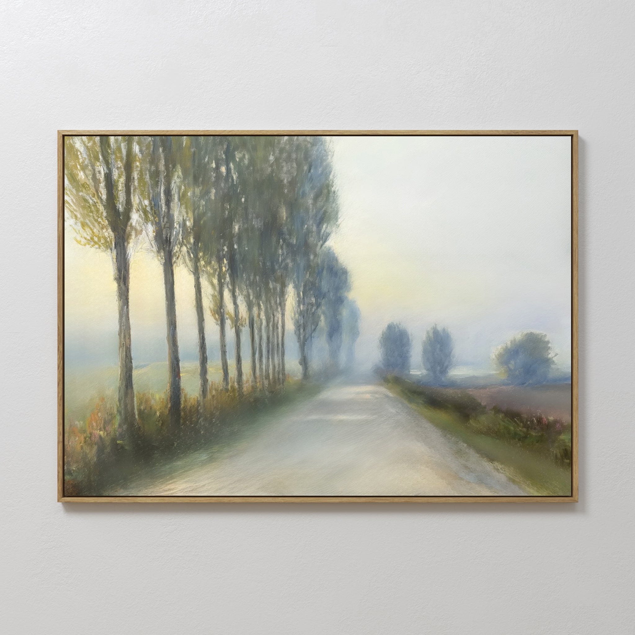 Forest Haze Canvas Art: A framed minimalist wall art of a country road lined with tall trees, fading into a misty distance under a hazy sky. Its soft, muted colors make it a tranquil accent for any space.