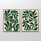 The Forest Leaves Set of 2 features framed abstract art prints with bold, dark green leaf shapes on a cream background, bringing a tranquil, Nordic Park vibe to your space when displayed side by side on a white wall.