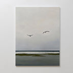 Freeflight Canvas Art features a calm seascape under a cloudy sky, with two birds over gentle waves and a dark green shoreline. Its muted colors offer peaceful, minimalist wall art—ideal for adding serene decor to any space.
