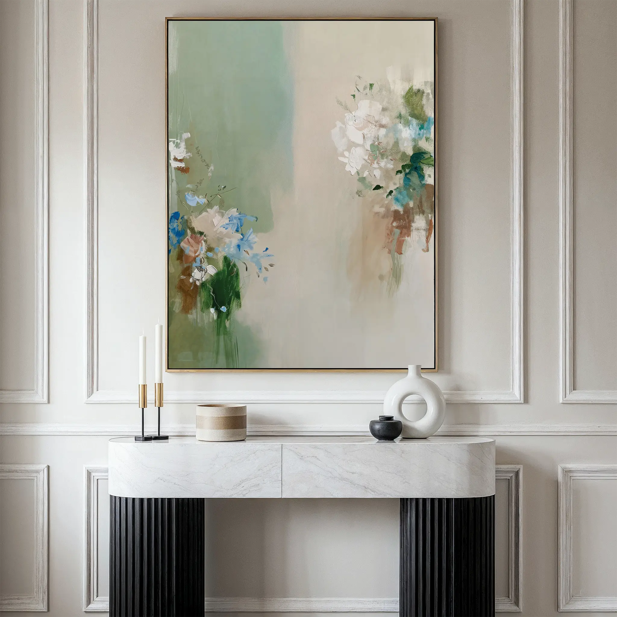 A minimalist room features a marble console table with elegant decor and the Garden Bloom Canvas Art, a large abstract floral wall art print in soft pastel colors, hanging on a paneled wall.