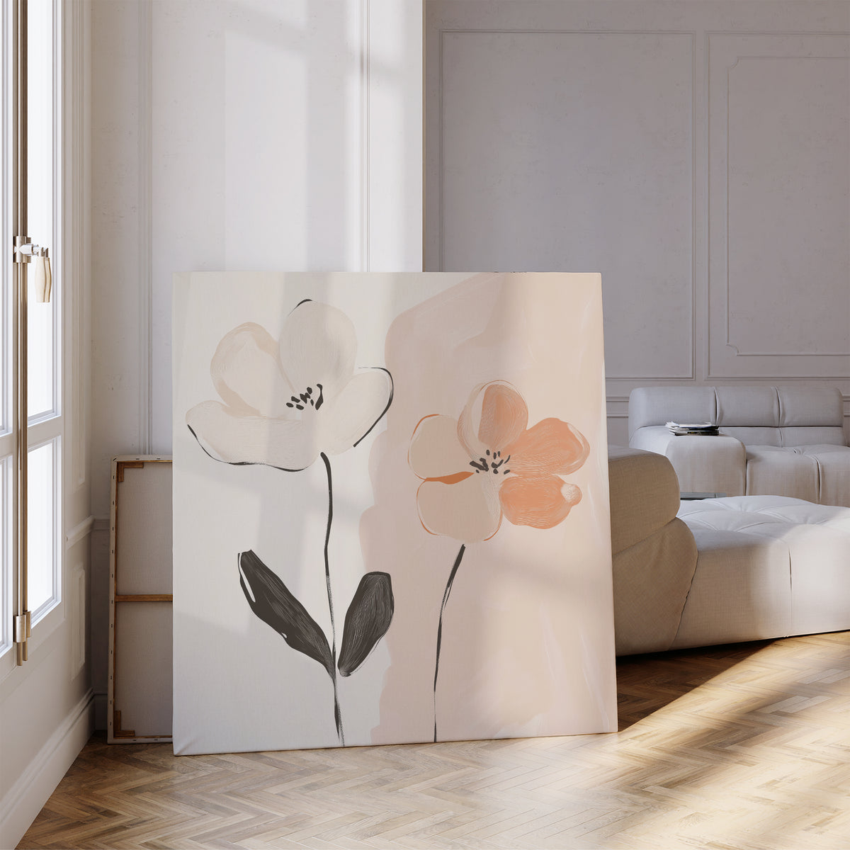 The Gentle Duo Canvas Art, featuring two abstract flowers in white and peach, leans against a wall in a bright living room with parquet floors and a white sofa, sunlight highlighting this minimalist floral artwork.