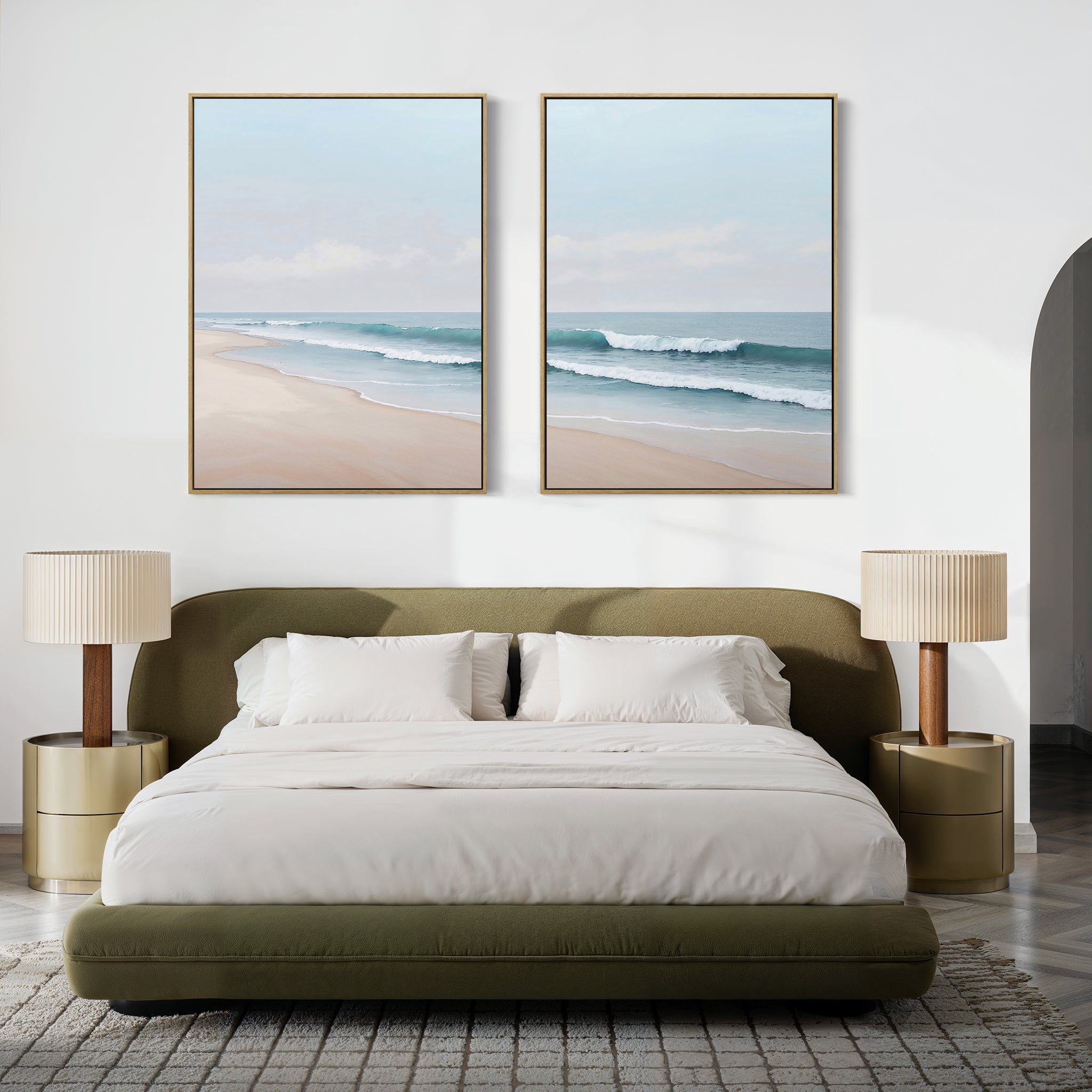 A modern bedroom features a green bed, white bedding, and gold nightstands with the Gentle Surf Set of 2 coastal wall art above the bed. Neutral decor and beach-inspired touches create a serene, minimalist space.