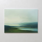 The Gentle Valleys Canvas Art – Horizontal features a soft, misty landscape with rolling hills and reflective waters, making it an ideal piece of minimalist wall art for elegant living room decor.