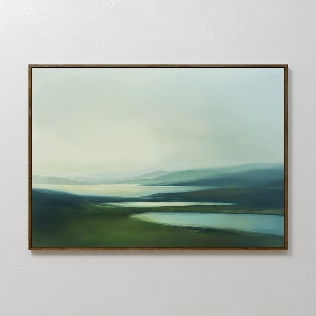 The Gentle Valleys Canvas Art – Horizontal features a framed abstract landscape in soft greens, blues, and whites, creating serene minimalist wall art that's perfect for living room decor on a plain white wall.