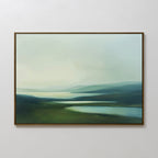 The Gentle Valleys Canvas Art – Horizontal features a framed abstract landscape in soft greens, blues, and whites, creating serene minimalist wall art that's perfect for living room decor on a plain white wall.