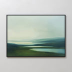 The Gentle Valleys Canvas Art – Horizontal features a framed abstract landscape in soft green, blue, and white tones, depicting rolling hills and reflective water—ideal serene wall art for minimalist living room decor.