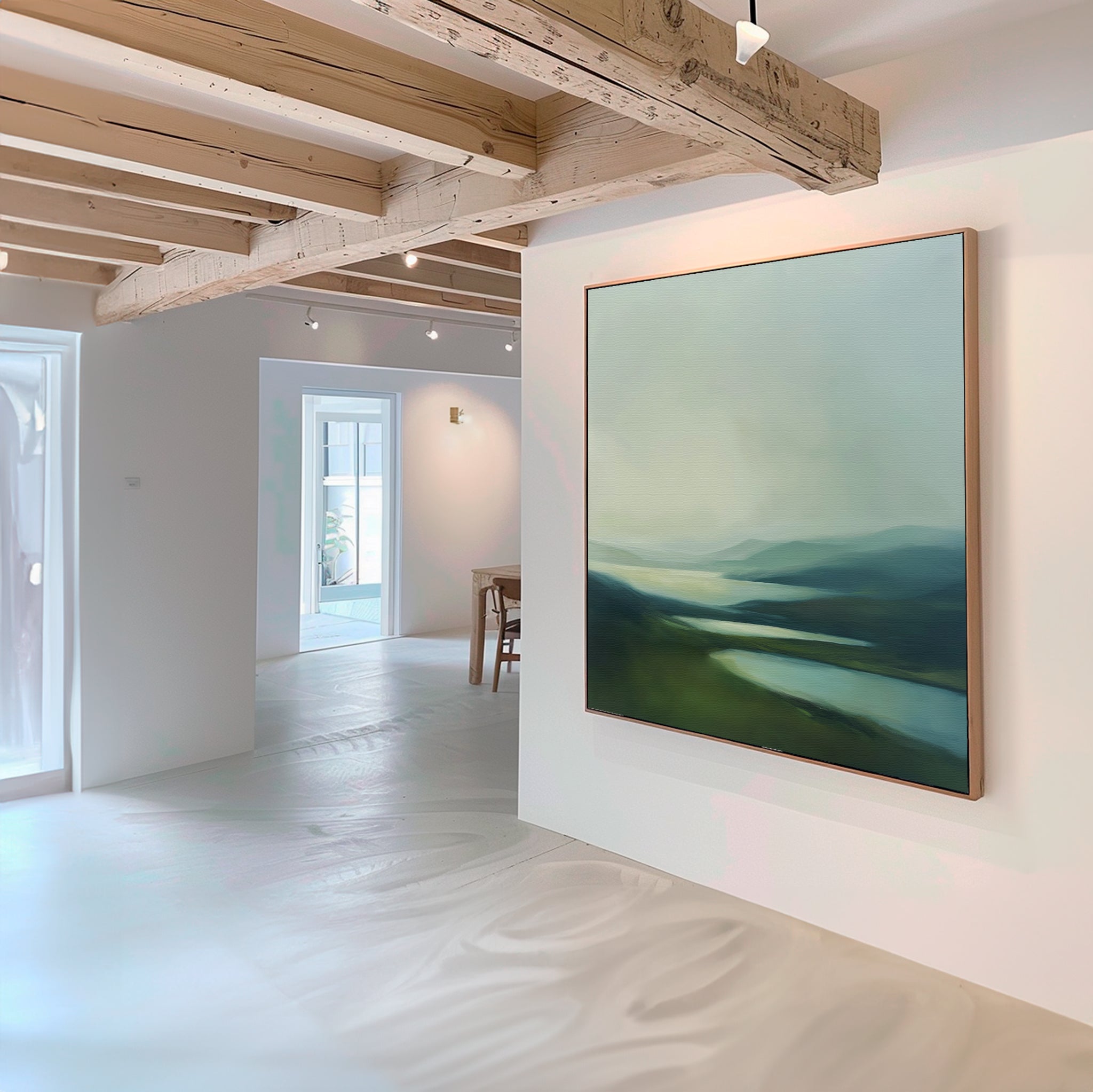 A modern, minimalist room with white walls and light wood beams features the Gentle Valleys Abstract Canvas Art in green and blue tones, adding serene living room decor as sunlight brightens the airy space.