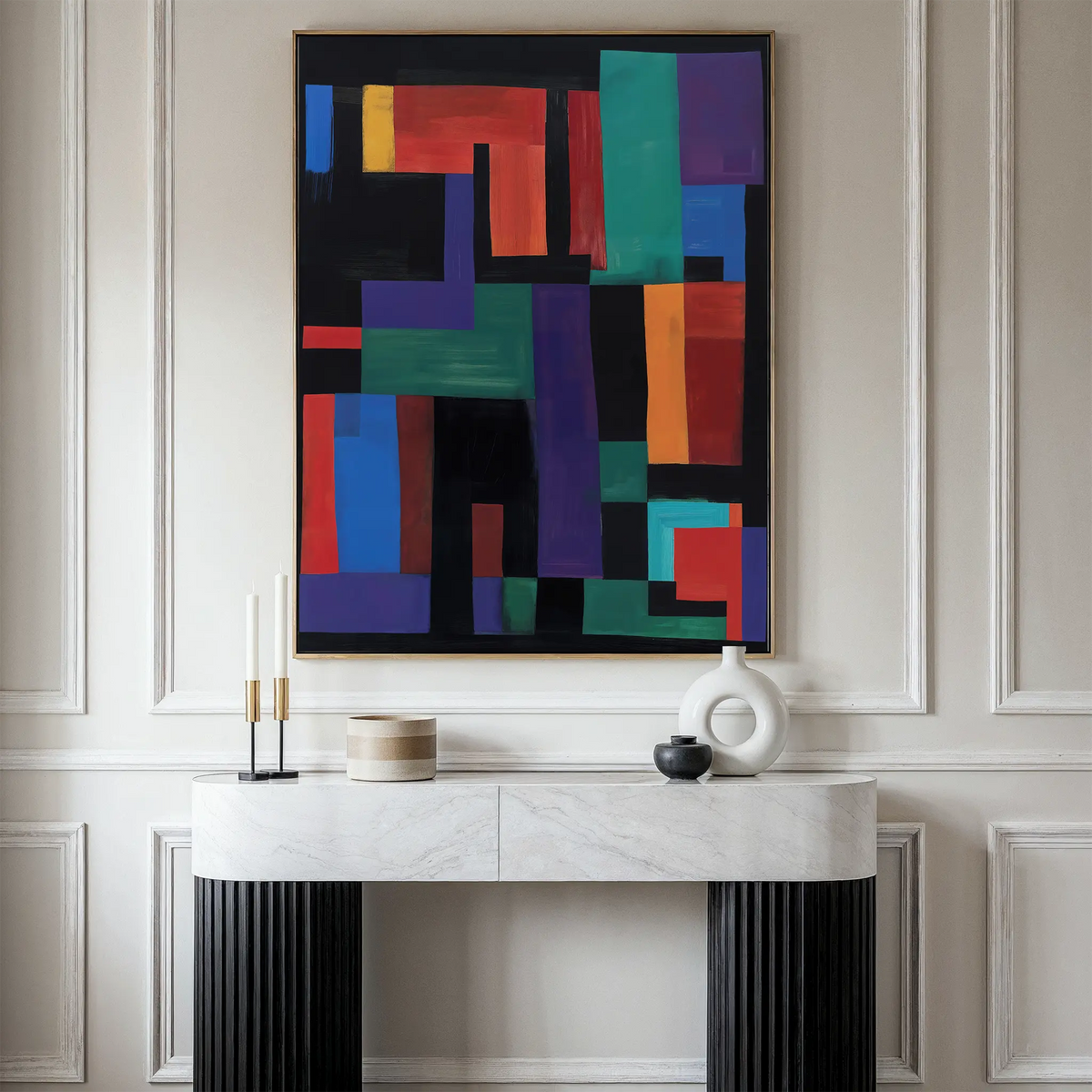 A modern entryway features a white marble console table with black ribbed legs, decorative vases, and candles. Above it hangs the Geometric Mosaic Canvas Art on a beige paneled wall.