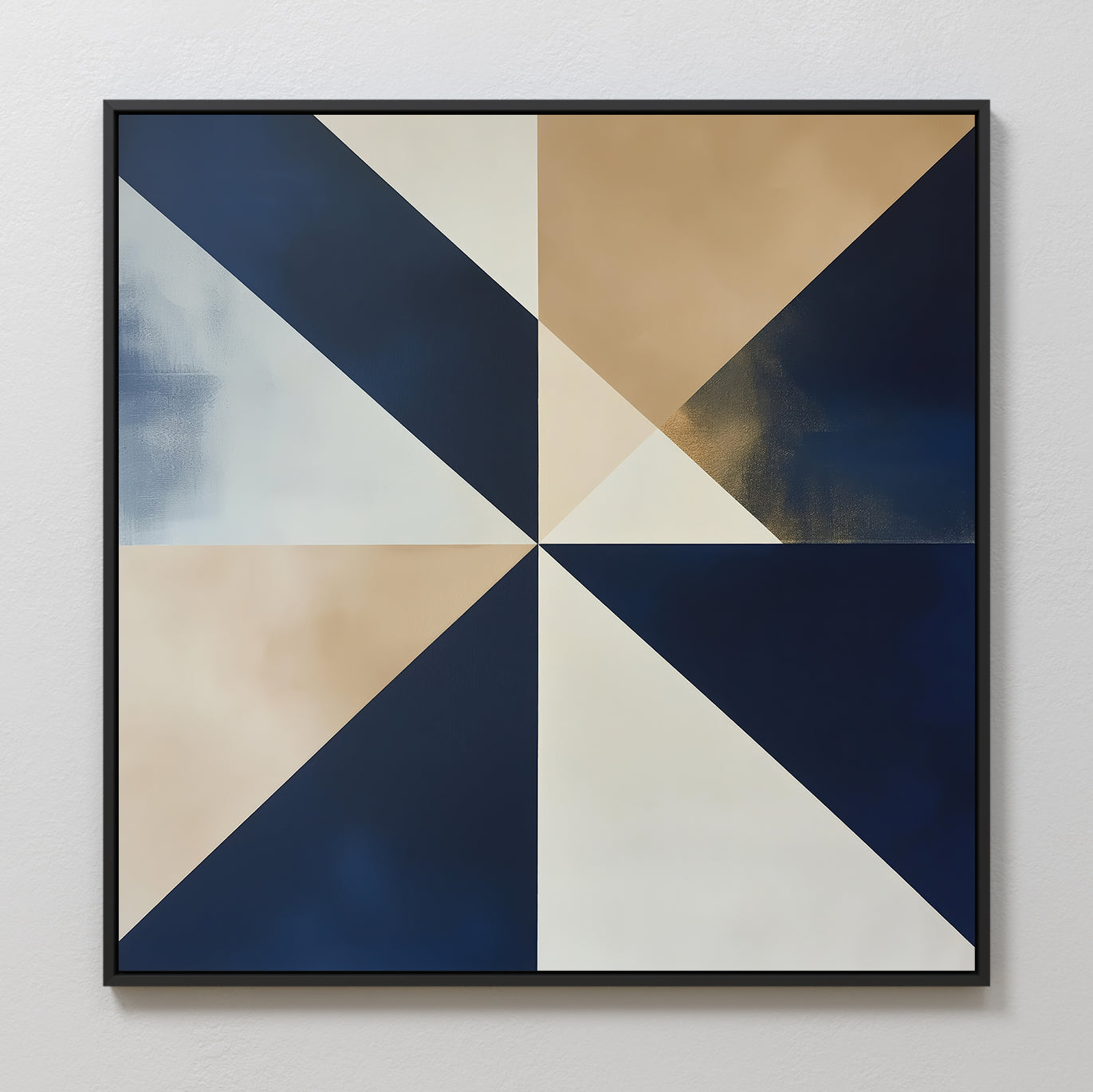 The Geometric Night Canvas Art features a square design with alternating navy blue, beige, and white triangles radiating from the center, framed in black. This modern minimalist piece adds a striking accent to any light-colored wall.