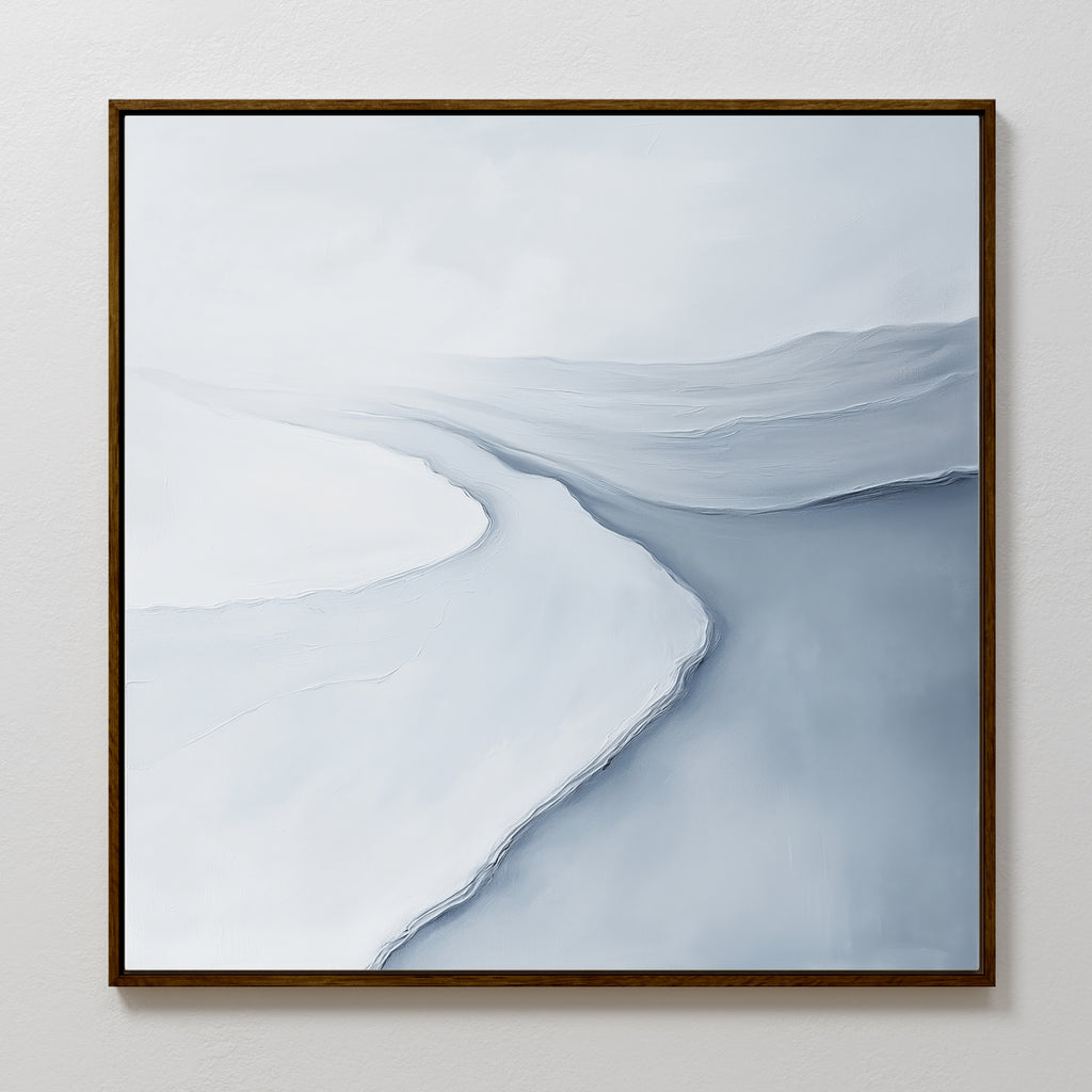 The Glacial Flow Canvas Art features abstract shades of white, gray, and blue forming a winding river on a minimalist canvas, elegantly framed in dark brown—perfect for enhancing modern living room decor.