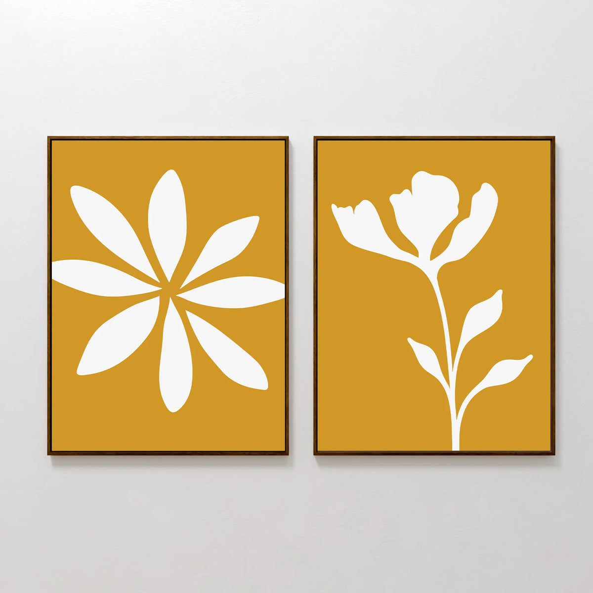 Golden Bloom Set of 2 features framed minimalist art prints with mustard yellow backgrounds—one with a white abstract flower and one with a stylized stem—ideal modern decor for lovers of chic, floral wall art.