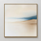 Golden Drift Canvas Art features minimalist abstract design with soft beige, white, and blue hues blending in serene gradients. Framed in a slim light wood frame, it’s perfect for adding an elegant touch to your living room’s white walls.