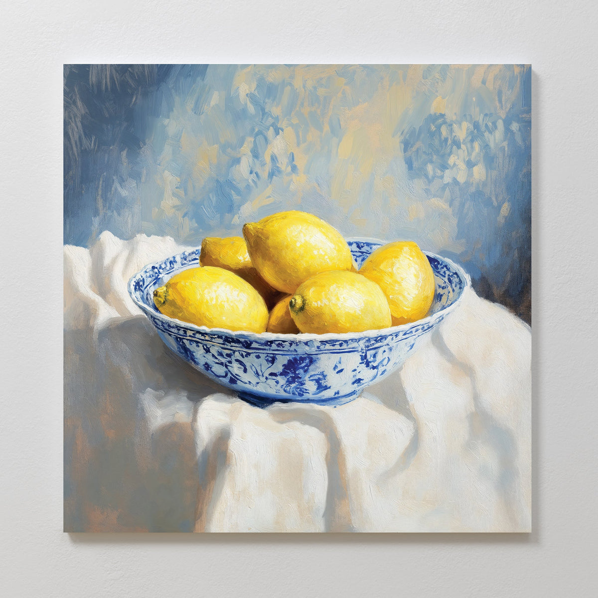 The Golden Fruit Canvas Art features a blue and white patterned bowl with six yellow lemons on a white cloth, set against a soft blue and yellow background—perfect vintage decor for your home.